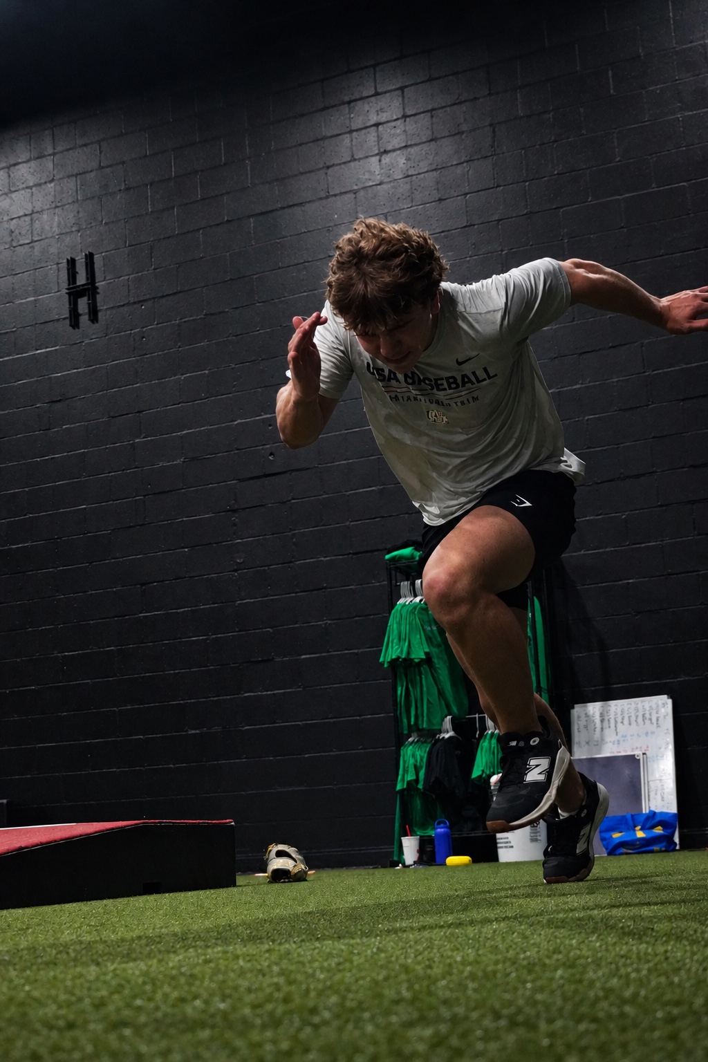 Alpha athlete sprinting across the facility turf